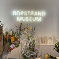 Rörstrand Museum. The reception neon sign with flowers from the opening, April 2022.